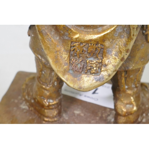 160 - A Chinese bronze figure of a warrior god, hands clasped in prayer, impressed seal mark verso, 23cm h... 