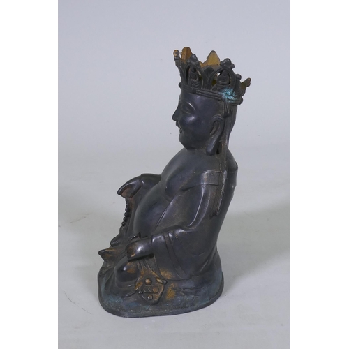 161 - An oriental bronze Buddhivistic seated figure bearing a rosary and ruyi, 23cm high