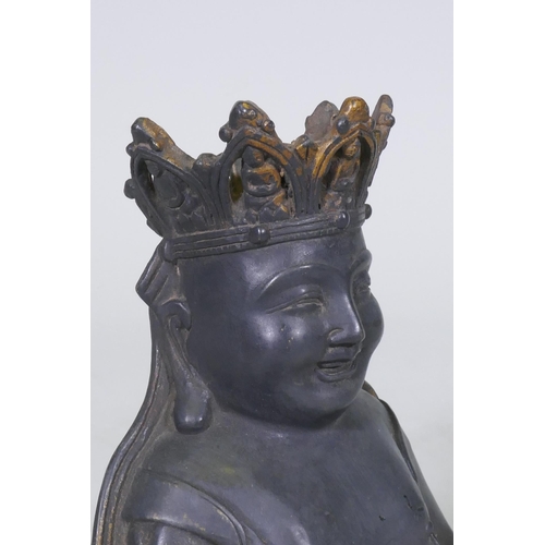 161 - An oriental bronze Buddhivistic seated figure bearing a rosary and ruyi, 23cm high