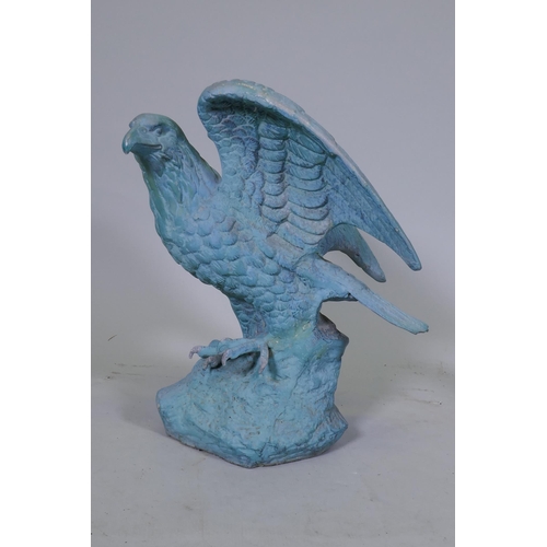 164 - A metal figure of an eagle with verdigris patination, 45cm high