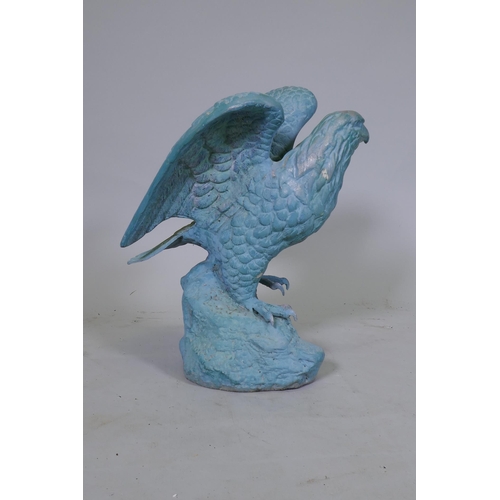 164 - A metal figure of an eagle with verdigris patination, 45cm high