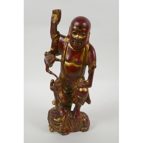 188 - A Chinese gilt and copper lacquered bronze figure of Lohan