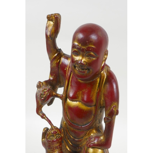 188 - A Chinese gilt and copper lacquered bronze figure of Lohan