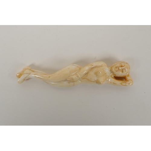 194 - A carved bone figure of a nude, oriental woman, 13cm  long