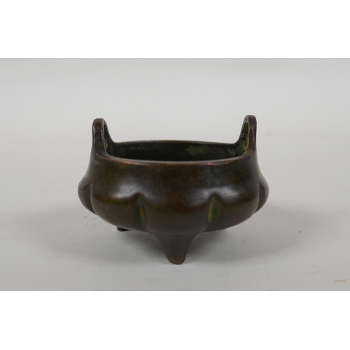 196 - An antique Chinese miniature bronze censer of gourd form with two handles and tripod supports, impre... 