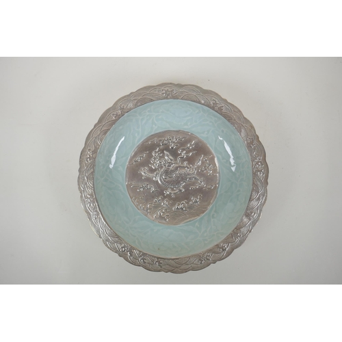 198 - A Chinese celadon and silver glazed porcelain bowl with lobed rim, decorated with a dragon and lotus... 