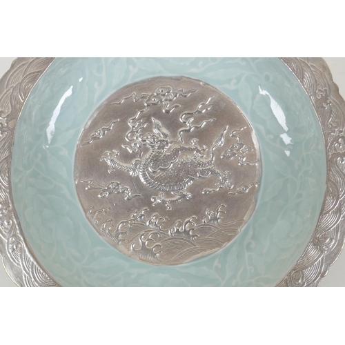 198 - A Chinese celadon and silver glazed porcelain bowl with lobed rim, decorated with a dragon and lotus... 