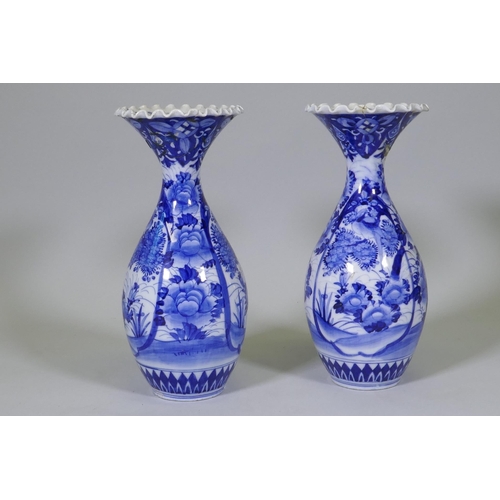 204 - A pair of Arita blue and white vases with flared necks and frilled rims, AF repairs to necks, 45cm h... 