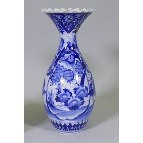 204 - A pair of Arita blue and white vases with flared necks and frilled rims, AF repairs to necks, 45cm h... 