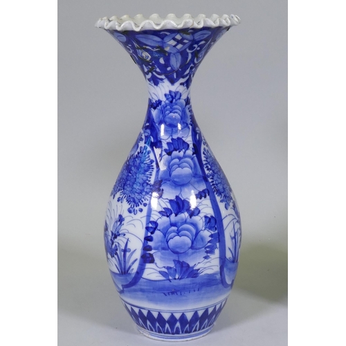 204 - A pair of Arita blue and white vases with flared necks and frilled rims, AF repairs to necks, 45cm h... 