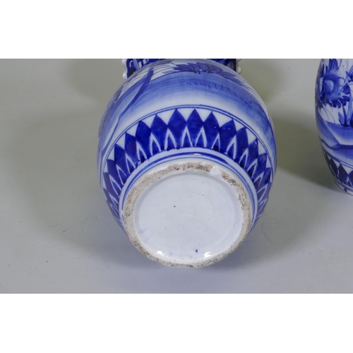 204 - A pair of Arita blue and white vases with flared necks and frilled rims, AF repairs to necks, 45cm h... 