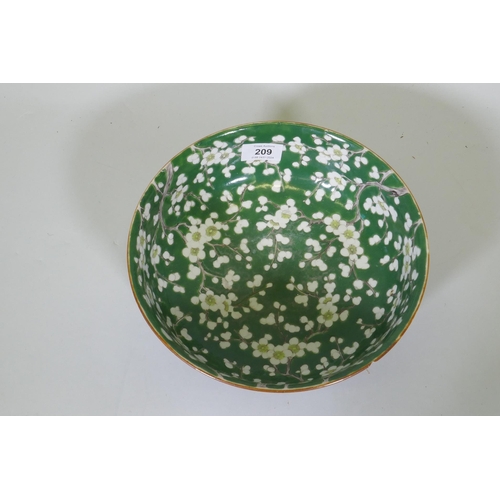 209 - A vintage green glazed Chinese bowl with prunus blossom decoration, 24.5cm diameter