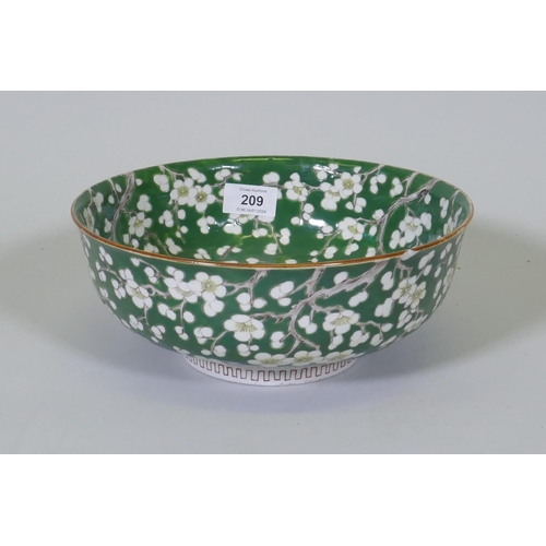 209 - A vintage green glazed Chinese bowl with prunus blossom decoration, 24.5cm diameter