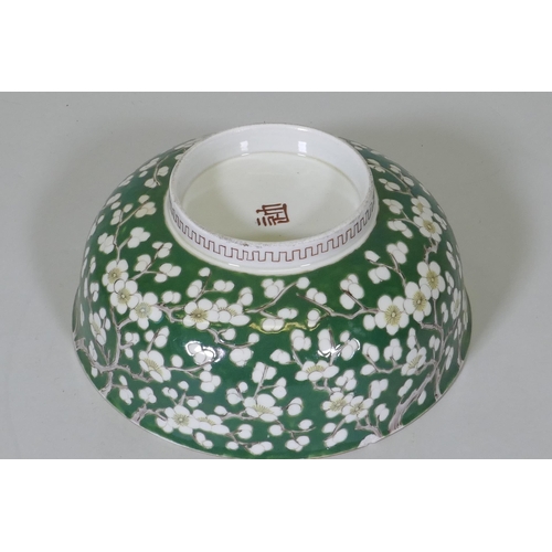 209 - A vintage green glazed Chinese bowl with prunus blossom decoration, 24.5cm diameter