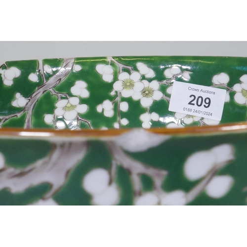 209 - A vintage green glazed Chinese bowl with prunus blossom decoration, 24.5cm diameter