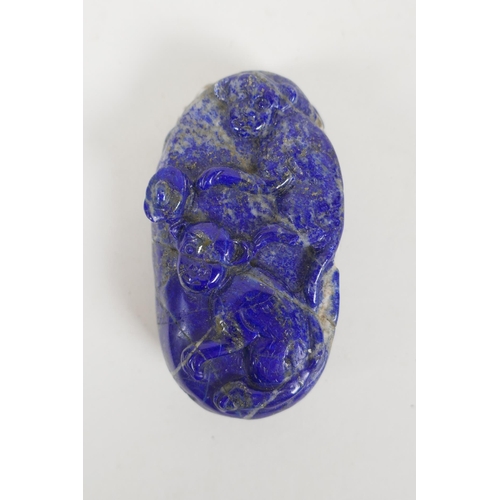 210 - A Chinese carved lapis lazuli pendant decorated with two monkeys, 8 x 5cm