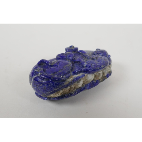 210 - A Chinese carved lapis lazuli pendant decorated with two monkeys, 8 x 5cm