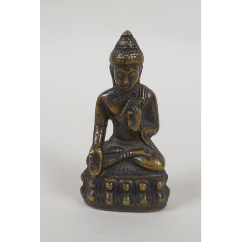 211 - A Tibetan bronze figure of Buddha, 7cm high