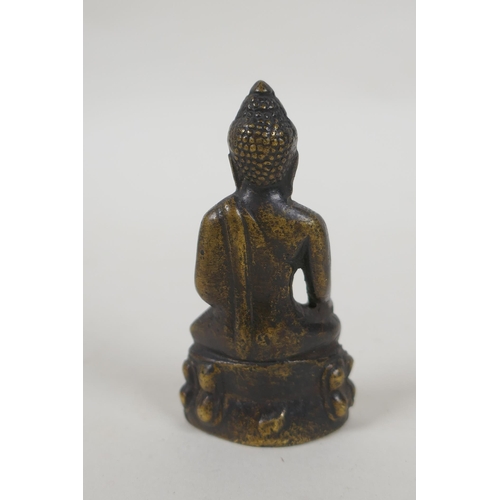 211 - A Tibetan bronze figure of Buddha, 7cm high