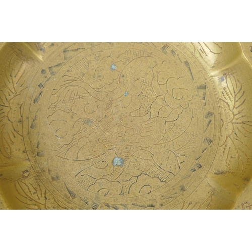 214 - A Chinese brass bowl with frilled rim, engraved dragon decoration, 21cm diameter