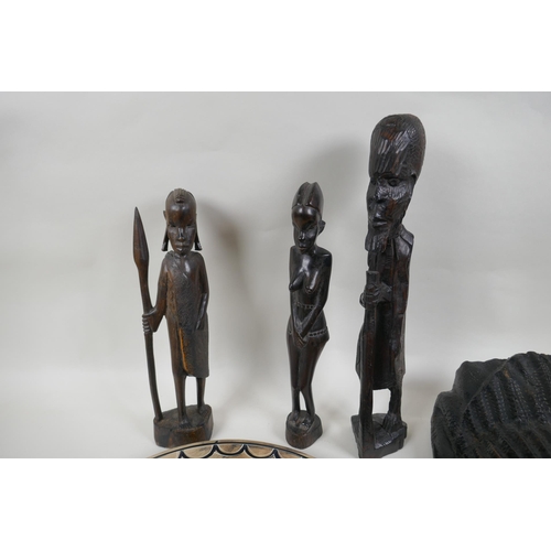 216 - Three African carved hardwood figures, an African carved hardwood wall mask and a soapstone charger ... 