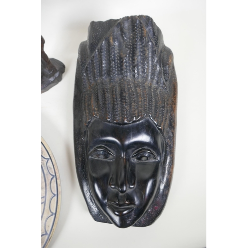 216 - Three African carved hardwood figures, an African carved hardwood wall mask and a soapstone charger ... 