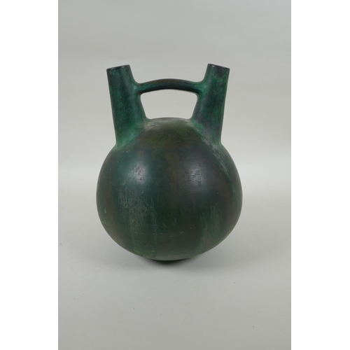 219 - A South American double spout  and bridge ceramic bottle with bronze style glaze, 25cm high