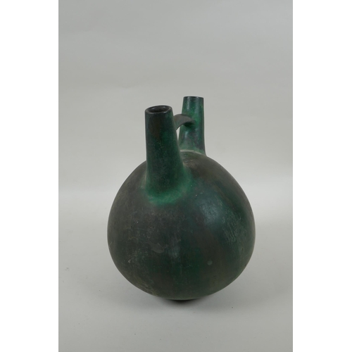 219 - A South American double spout  and bridge ceramic bottle with bronze style glaze, 25cm high