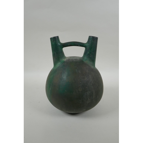 219 - A South American double spout  and bridge ceramic bottle with bronze style glaze, 25cm high