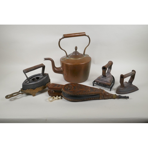 222 - A quantity of antique fireside items to include a copper kettle, cast iron and bronze trivets, irons... 