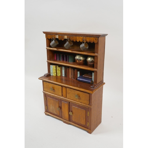 224 - A miniature mahogany Welsh dresser and contents, 26cm high