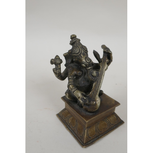 225 - An Indian bronze figure of Ganesh playing a sitar, and a smaller bronze figure of a tiger, largest 9... 