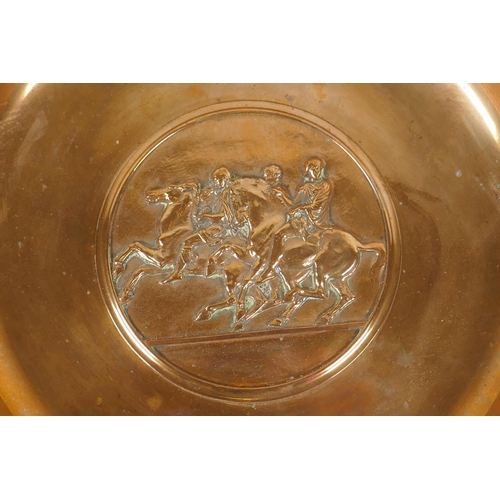 236 - A Barbedienne bronze tazza, the centre embossed with horses and riders, the handles supported on Bac... 