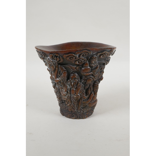 240 - A Chinese faux horn libation cup with carved decoration of the Eight Immortals, 4 character mark to ... 