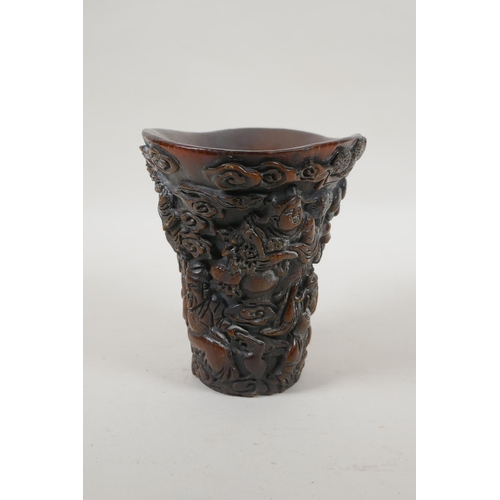 240 - A Chinese faux horn libation cup with carved decoration of the Eight Immortals, 4 character mark to ... 