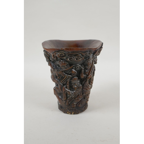 240 - A Chinese faux horn libation cup with carved decoration of the Eight Immortals, 4 character mark to ... 