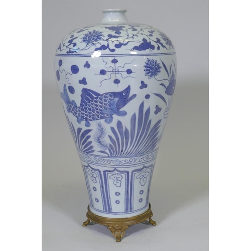 241 - A Chinese ming style blue and white baluster shaped vase decorated with carp amongst reeds and lotus... 