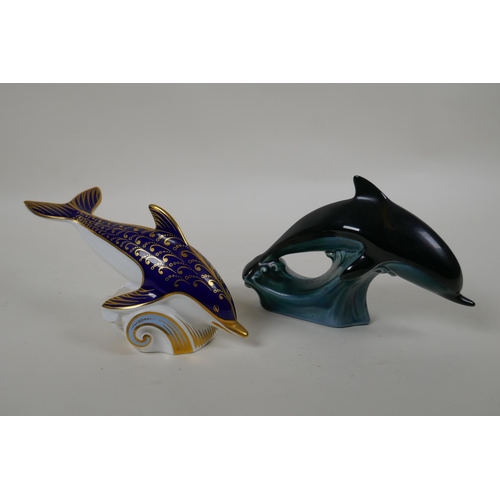 248 - A Royal Crown Derby porcelain dolphin paperweight, together with a Poole Pottery dolphin, largest 15... 