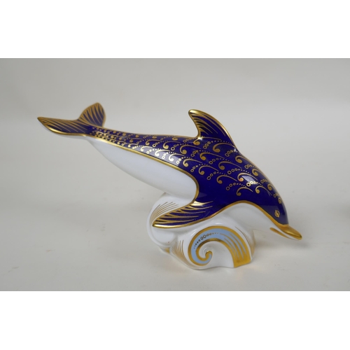 248 - A Royal Crown Derby porcelain dolphin paperweight, together with a Poole Pottery dolphin, largest 15... 