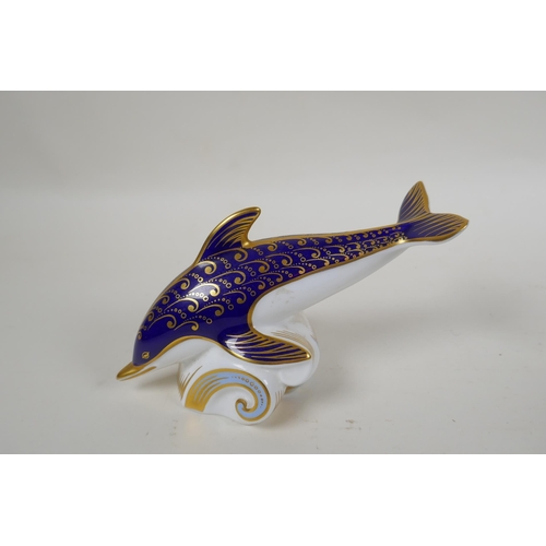 248 - A Royal Crown Derby porcelain dolphin paperweight, together with a Poole Pottery dolphin, largest 15... 