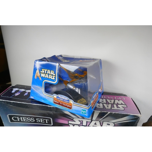 249 - A collection of Star Wars toys, to include a chess set, action figure, starships and moneybox