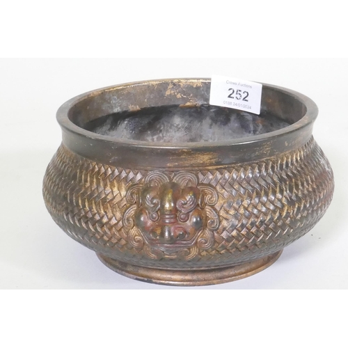 252 - A Chinese bronze censer with mask decoration and woven basket style body, impressed seal mark to bas... 