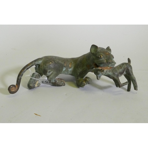 253 - An Eastern bronze figure of a lion with prey, 20 x 7cm high