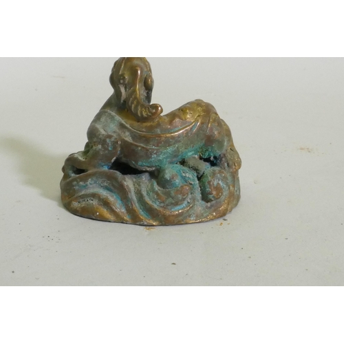 259 - An Eastern bronze figure of a horned dragon, 5cm high