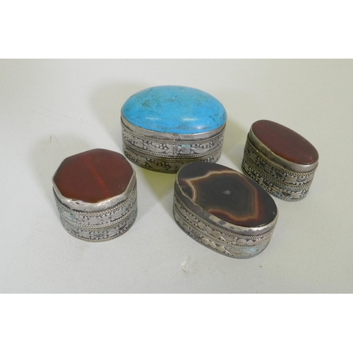 260 - Three white metal pill boxes with inset agate tops, largest 4.5cm long, and another with turquoise t... 