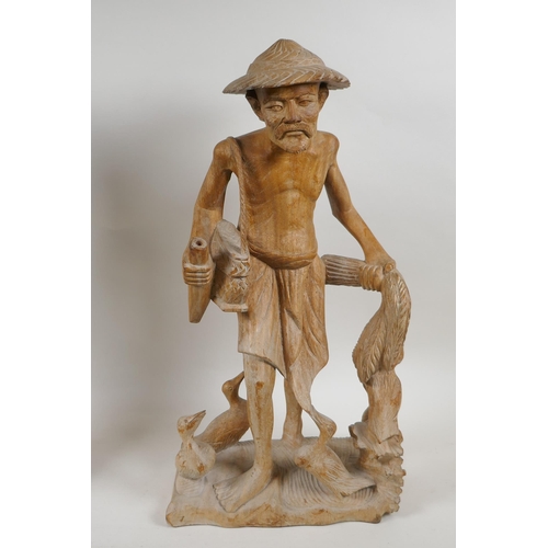 283 - A Balinese carved hardwood figure of a dancer, and an oriental carved wood figure of a duck farmer, ... 