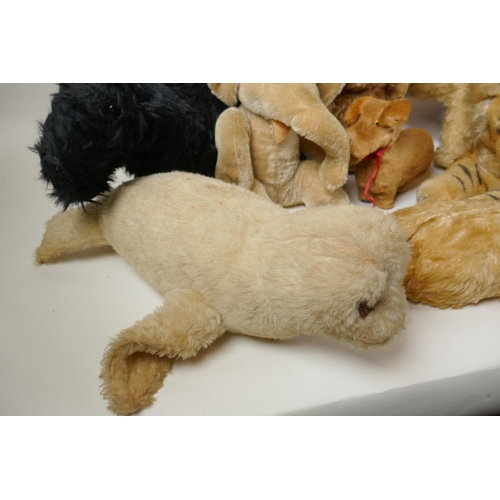 291 - A collection of vintage stuffed toys including an Angus Terrier, plush dog with rubber head, clockwo... 