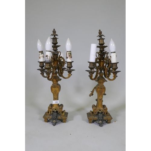 295 - A pair of ormolu and bronze four branch candelabra lamps, one arm AF, 58cm high