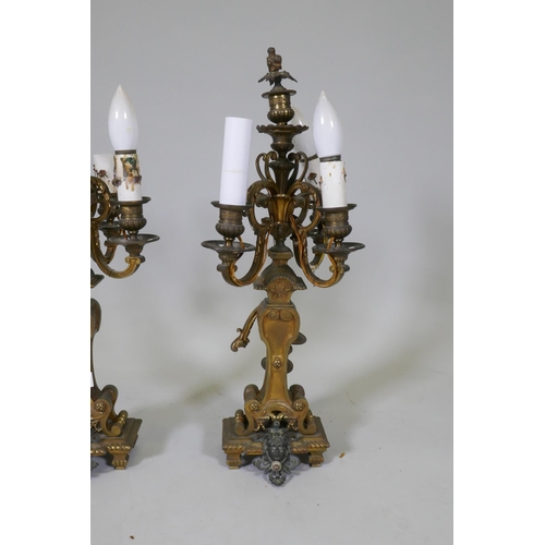 295 - A pair of ormolu and bronze four branch candelabra lamps, one arm AF, 58cm high