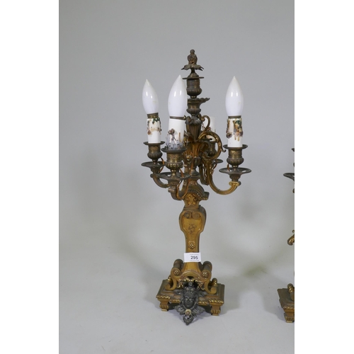 295 - A pair of ormolu and bronze four branch candelabra lamps, one arm AF, 58cm high